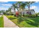 Charming home with a well-manicured lawn and lush tropical landscaping, offering inviting curb appeal at 4527 Barracuda Dr, Bradenton, FL 34208