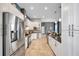 Modern kitchen with stainless steel appliances, white cabinetry, and a view of the dining area at 4527 Barracuda Dr, Bradenton, FL 34208