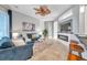 Cozy living room area with stylish couches, modern fireplace, and view into kitchen and dining area at 4527 Barracuda Dr, Bradenton, FL 34208