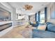 Bright, open living room featuring comfortable seating and a modern fireplace with seamless access to the kitchen at 4527 Barracuda Dr, Bradenton, FL 34208