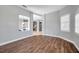 Open-concept living room with wood flooring, natural light, and neutral gray walls at 4527 Barracuda Dr, Bradenton, FL 34208