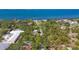 Aerial view showcases the property nestled among mature trees, offering privacy and stunning views of the bay at 480 58Th St, Sarasota, FL 34243