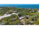 Beautiful aerial view of a luxurious waterfront estate surrounded by lush greenery and stunning ocean views at 480 58Th St, Sarasota, FL 34243