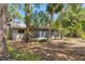 Spacious backyard surrounded by lush greenery and mature trees, creating a serene outdoor space at 480 58Th St, Sarasota, FL 34243