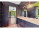 Spacious bathroom featuring double sinks, a large mirror, and access to the bedroom at 480 58Th St, Sarasota, FL 34243