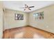 Hardwood floor bedroom with ceiling fan and natural light from windows at 480 58Th St, Sarasota, FL 34243
