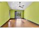 Bright bedroom with hardwood floors, a ceiling fan, and sliding doors leading to the outside at 480 58Th St, Sarasota, FL 34243
