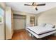 Bedroom featuring a ceiling fan, hardwood floors, closet, and natural light from windows at 480 58Th St, Sarasota, FL 34243