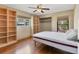 Bright bedroom with a ceiling fan, hardwood floors, closet, and natural light from windows at 480 58Th St, Sarasota, FL 34243