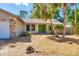 Close up of the home's entrance showing stone accents, a green front door, and xeriscaping at 480 58Th St, Sarasota, FL 34243
