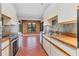 Open concept kitchen with brick floors, stainless steel appliances, wood counters, and abundant natural light at 480 58Th St, Sarasota, FL 34243