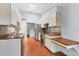 Bright kitchen features brick floors, stainless steel appliances, and wood countertops at 480 58Th St, Sarasota, FL 34243