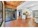 Open concept kitchen featuring brick floors, stainless steel appliances, wood countertops, with sliding glass doors and an open floor plan at 480 58Th St, Sarasota, FL 34243