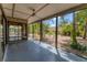 Relaxing screened patio with ceiling fan and views of the lush backyard at 480 58Th St, Sarasota, FL 34243
