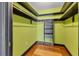 Walk-in closet featuring hardwood floors and custom shelving at 480 58Th St, Sarasota, FL 34243
