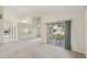 Bright living room with high ceilings and sliding doors to the screened-in patio at 4829 Village Gardens Dr # 169, Sarasota, FL 34234