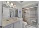 Bathroom with tiled shower, white vanity, and neutral color palette at 501 Lakeside Dr # 501, Bradenton, FL 34210