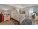 Comfortable bedroom with a floral bedspread, light walls, and a sliding glass door to a balcony at 501 Lakeside Dr # 501, Bradenton, FL 34210