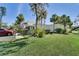 Well-maintained front lawn and landscaping, complemented by palm trees and a modern building style, enhancing curb appeal at 501 Lakeside Dr # 501, Bradenton, FL 34210
