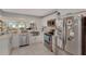 Beautiful, updated kitchen featuring stainless steel appliances, white cabinetry, and a view into the living area at 501 Lakeside Dr # 501, Bradenton, FL 34210
