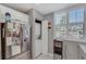 Bright kitchen features white cabinets, stainless steel appliances, and convenient laundry area with washer and dryer at 501 Lakeside Dr # 501, Bradenton, FL 34210