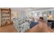 Comfortable living room featuring a floral sofa set, bright natural light, and views into the adjacent room at 501 Lakeside Dr # 501, Bradenton, FL 34210