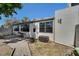 View of the rear exterior featuring a brick paved patio area surrounded by a white building with large windows at 501 Lakeside Dr # 501, Bradenton, FL 34210