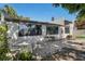 Rear exterior showing an outdoor dining area with a round table, chairs, and a brick paved patio at 501 Lakeside Dr # 501, Bradenton, FL 34210