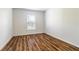 Bright, vacant bedroom with hardwood floors and a window at 5086 Raven St, North Port, FL 34286