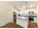 Well-lit kitchen featuring stainless steel appliances, granite countertops, and modern pendant lighting at 5086 Raven St, North Port, FL 34286