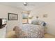Comfortable bedroom with a floral bedspread, a TV, and a window with bright natural light at 5729 Avista Dr, Sarasota, FL 34243
