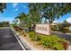 Avista community sign surrounded by vibrant landscaping and palm trees on a bright, sunny day at 5729 Avista Dr, Sarasota, FL 34243