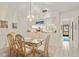 Bright dining room with a glass table, seating for six, and access to the kitchen at 5729 Avista Dr, Sarasota, FL 34243