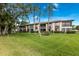 Well-maintained condo building with green lawns, mature trees and screened lanais offering comfortable outdoor living at 5729 Avista Dr, Sarasota, FL 34243