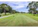 Expansive golf course view with manicured greens and mature trees, showcasing the community's scenic golf course at 5729 Avista Dr, Sarasota, FL 34243