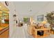 Spacious living room featuring a vaulted ceiling, wet bar, and large windows at 5729 Avista Dr, Sarasota, FL 34243