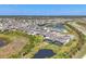 Expansive aerial view of a residential community featuring homes, ponds, and lush landscapes, offering a serene living environment at 5833 Millennium Silver Ct, Sarasota, FL 34238