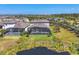 Aerial view of a private backyard and pool with a serene pond, nestled within a peaceful residential community at 5833 Millennium Silver Ct, Sarasota, FL 34238