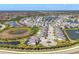 Beautiful aerial view of a luxurious home in a waterfront community with lush landscaping and serene lakes at 5833 Millennium Silver Ct, Sarasota, FL 34238