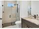 This bathroom features a gray vanity with granite countertop and a glass-enclosed shower with rainfall showerhead at 5833 Millennium Silver Ct, Sarasota, FL 34238