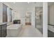 This bathroom has a soaking tub with marble surround, a walk-in closet, and a glass shower stall at 5833 Millennium Silver Ct, Sarasota, FL 34238