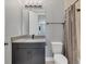 Modern bathroom features a large vanity, gray cabinets, and shower-tub combo with curtain at 5833 Millennium Silver Ct, Sarasota, FL 34238