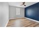 Bedroom with hardwood floors offers natural light with a ceiling fan at 5833 Millennium Silver Ct, Sarasota, FL 34238