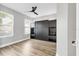 This bedroom has a built-in storage unit, wood-look floors, and natural light from the windows at 5833 Millennium Silver Ct, Sarasota, FL 34238