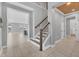 Open foyer with tile flooring, a staircase, and views into the kitchen and dining area at 5833 Millennium Silver Ct, Sarasota, FL 34238