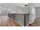 Open hallway featuring modern railing, chandelier, wood floors, and plenty of natural light at 5833 Millennium Silver Ct, Sarasota, FL 34238
