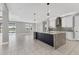 Kitchen island with granite countertops and views into the living space and through the large sliding glass doors at 5833 Millennium Silver Ct, Sarasota, FL 34238
