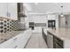 Gourmet kitchen with stainless appliances, custom cabinets, and a decorative backsplash at 5833 Millennium Silver Ct, Sarasota, FL 34238