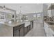Open kitchen features a large island, stainless steel appliances, pendant lighting and views to the lanai at 5833 Millennium Silver Ct, Sarasota, FL 34238