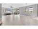 Bright living room features large windows, modern ceiling fan, and sliding glass doors to the screened lanai at 5833 Millennium Silver Ct, Sarasota, FL 34238